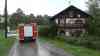 Land unter in Oberbayern: Sandsäcke gegen Wassermassen – Straße wird durch Überflutung unpassierbar – Feuerwehr muss Wall errichten: Gasthof rüstet sich mich liegenden Biertischen gegen Flut